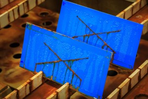 Multiple corrosion test specimens arranged by testing technique including salt spray and immersion