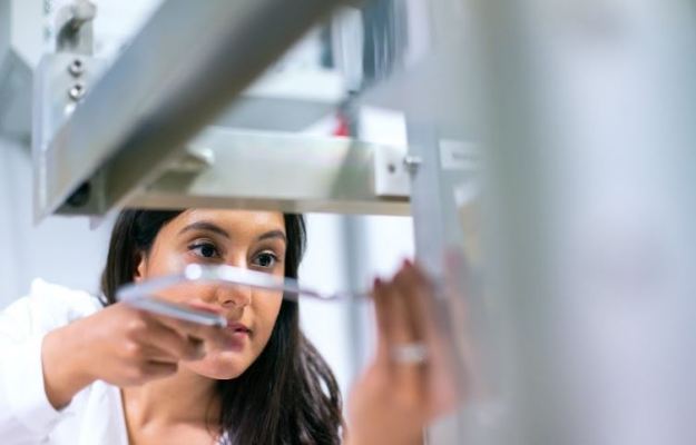 Composite specimen in V-notched rail shear fixture loaded for in-plane shear strength measurement