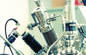 Automotive body panel specimen undergoing tensile and crash impact testing in test lab