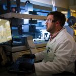 V-notched composite specimen positioned in rail shear fixture for ASTM D7078 testing