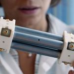 Thermocouple being calibrated against NIST-traceable reference standard in temperature calibration bath