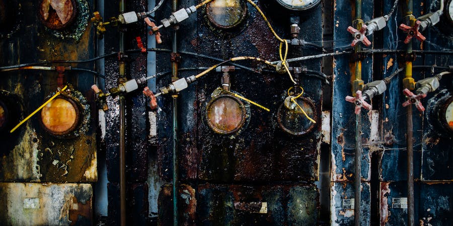 SEM image showing corrosion products and pitting on stainless steel surface