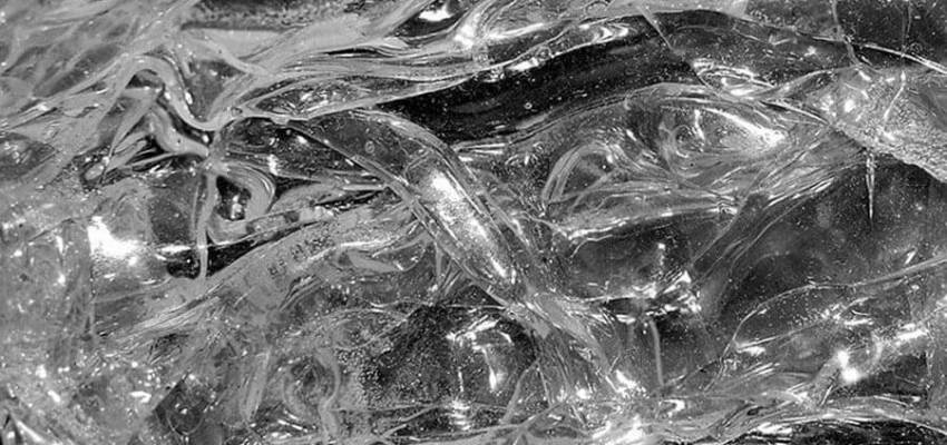 Trouser tear test specimen being pulled apart at cut in plastic film for ASTM D1938 tear force measurement