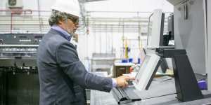 Universal testing machine with calibration weights attached to load cell for ASTM E4 verification