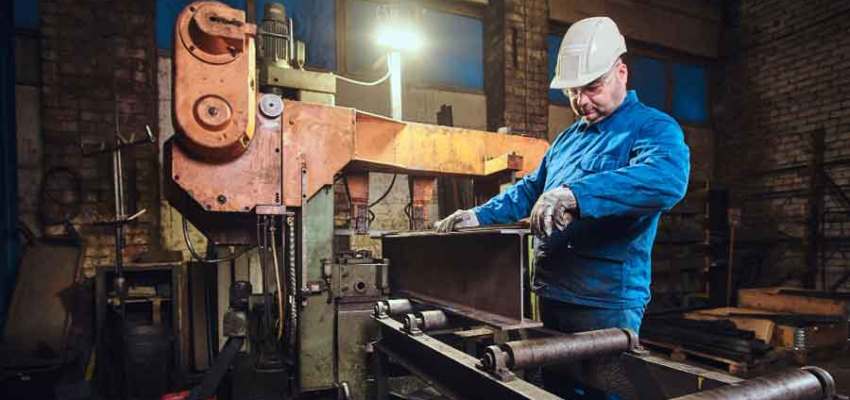 Manufacturing quality inspector reviewing metal test certificates for tensile and hardness results