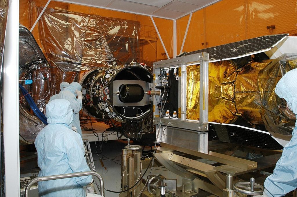 Technician performing Magnetic Particle Testing on an aerospace turbine component.